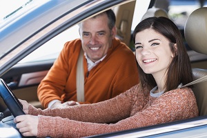 Teenager with father learning to drive